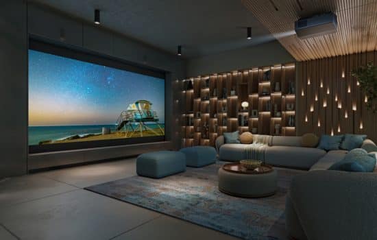 A casual home theater with a sectional, large screen, and Sony projector.